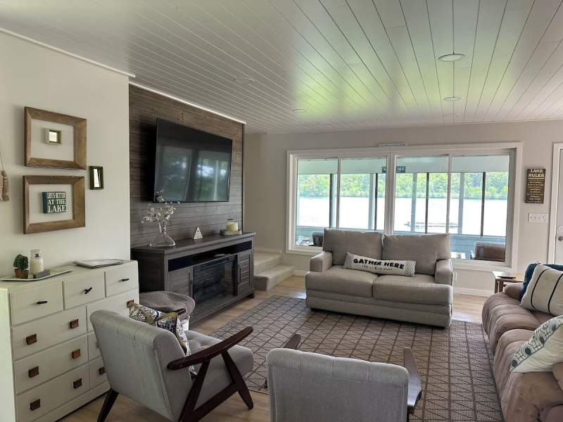 Living room at Pine Island Retreat with seating and lake-facing windows
